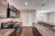 Thumbnail 14 of 49 - a kitchen with granite countertops and stainless steel appliances