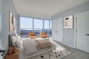 Thumbnail 4 of 29 - 3thirty3 new rochelle ny apartment high rise photo of bedroom with large windows and modern furnishings