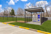 Thumbnail 6 of 35 - a bus stop with a fence and a toilet