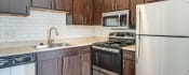 Thumbnail 19 of 30 - dark wood kitchen with stainless steel appliances