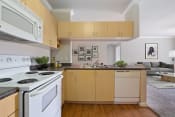 Thumbnail 1 of 22 - a kitchen with white appliances and wooden cabinets