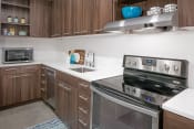 Thumbnail 3 of 45 - Two Bedroom Apartments in South Portland OR - Oxbow49 - Lavish Kitchen with Stainless-Steel Appliances