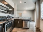 Thumbnail 8 of 14 - a kitchen with stainless steel appliances and granite countertops