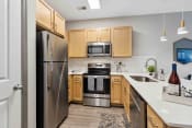 Thumbnail 2 of 29 - Sage at 1240 apartments in Mount Pleasant South Carolina photo of kitchen with oak cabinets and stainless steel appliances