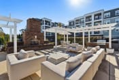 Thumbnail 11 of 29 - Sage at 1240 apartments in Mount Pleasant South Carolina photo of sundeck with outdoor seating, fireplace and grills