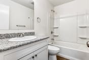 Thumbnail 8 of 19 - Whitney Manor Apartments in Gretna, LA photo of bathroom with sink, toilet and bathtub