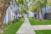 Thumbnail 19 of 19 - Whitney Manor Apartments in Gretna, LA photo of community buildings with greenery in between