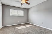 Thumbnail 15 of 19 - Whitney Manor Apartments in Gretna, LA photo of bedroom with plush carpeting and ceiling fan