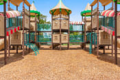 Thumbnail 5 of 30 - a playground with a tower with a slide and chairs