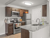 Thumbnail 12 of 30 - apartment kitchen in Holly Michigan with refrigerator, oven, and microwave