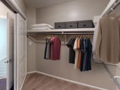 Thumbnail 6 of 24 - a walk in closet with a closet organizer and shelves