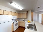 Thumbnail 4 of 24 - a kitchen with white appliances and wooden cabinets