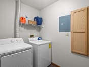Thumbnail 15 of 22 - a white laundry room with a washer and dryer and a blue cabinet