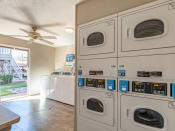 Thumbnail 8 of 24 - On-Site Laundry Facility at Camelot Apartments