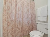 Thumbnail 15 of 26 - apartment bathroom with a toilet and a shower curtain