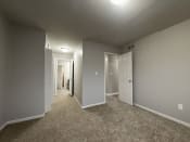 Thumbnail 12 of 18 - a bedroom with gray walls and carpet
