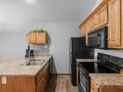 Thumbnail 4 of 24 - a kitchen with black appliances and granite counter tops