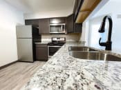 Thumbnail 1 of 22 - hully equipped kitchen with granite coutnertops at huntington glen