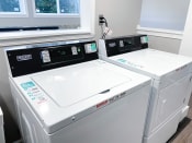 Thumbnail 19 of 22 - a washer and dryer sit next to each other in a laundry room