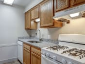 Thumbnail 4 of 22 - a kitchen with wood cabinets and white appliances