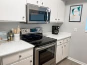 Thumbnail 4 of 25 - kitchen with microwave and oven at shoreline landing apartments