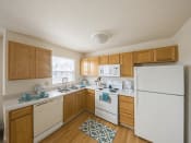 Thumbnail 3 of 19 - a kitchen with white appliances and wooden cabinets