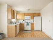 Thumbnail 2 of 19 - a kitchen with white appliances and wooden cabinets