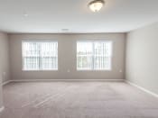 Thumbnail 10 of 19 - an empty room with three windows and a carpeted floor
