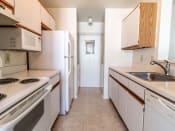 Thumbnail 7 of 24 - a kitchen with white appliances and wooden cabinets
