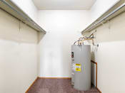 Thumbnail 11 of 23 - a room with a water heater and a radiator in the corner