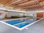 Thumbnail 23 of 28 - a large indoor swimming pool with a wooden ceiling