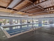 Thumbnail 19 of 28 - a large indoor swimming pool with a wooden ceiling