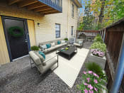 Thumbnail 14 of 22 - a patio with couches and a coffee table in a backyard