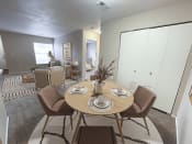 Thumbnail 2 of 21 - a dining area with a table and chairs and a living room in the background