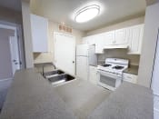 Thumbnail 3 of 21 - a kitchen with white cabinets and white appliances