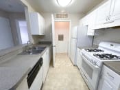 Thumbnail 4 of 21 - a kitchen with white cabinets and white appliances