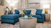 Thumbnail 1 of 23 - a living room with blue couches and a coffee table