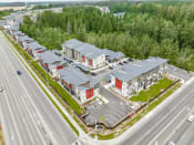 Thumbnail 29 of 30 - arial view of a row of houses with parking lot and trees in the background