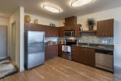 Thumbnail 13 of 22 - a kitchen with wooden cabinets and stainless steel appliances