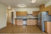 Thumbnail 7 of 22 - a kitchen with wooden cabinets and stainless steel appliances