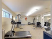 Thumbnail 12 of 18 - Residential gym area with treadmill and various other types of equipment at Gainsborough Court Apartments, Fairfax