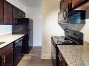 Thumbnail 3 of 18 - Kitchen area with granite counter tops in apartment unit at Gainsborough Court Apartments, Virginia, 22030