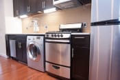 Thumbnail 15 of 25 - a kitchen with stainless steel appliances and black cabinets