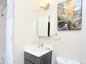 Thumbnail 8 of 22 - a bathroom with a white sink and toilet and a white shower curtain