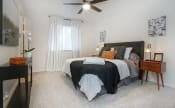 Thumbnail 7 of 25 - a bedroom with a bed and a ceiling fan at Elevate at Huebner Grove, San Antonio Texas