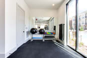 Thumbnail 29 of 41 - the gym with large windows and black carpeted flooring