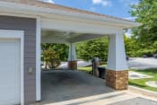 Thumbnail 33 of 47 - a carport with a driveway in front of a house