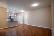 Thumbnail 30 of 30 - an empty living room and kitchen with wood flooring