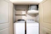 Thumbnail 25 of 30 - a washer and dryer in a laundry room with white cabinets
