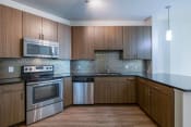 Thumbnail 38 of 53 - a kitchen with stainless steel appliances and wooden cabinets